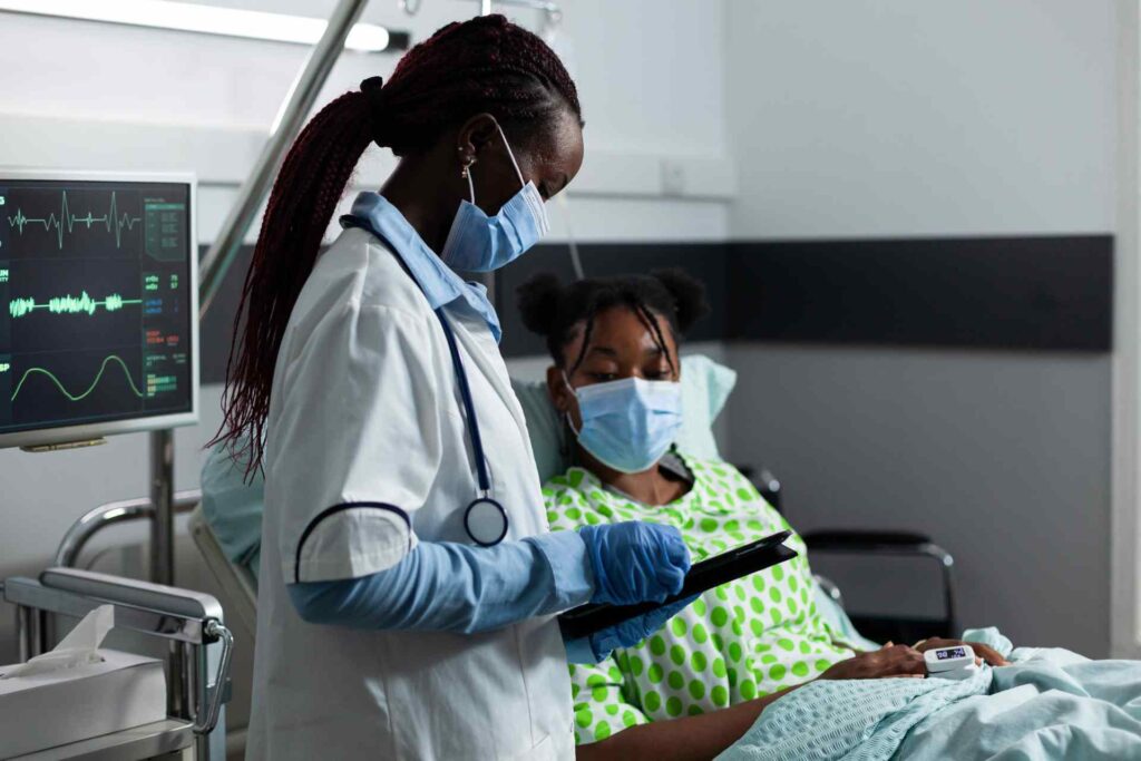 medic-of-african-ethnicity-helping-sick-patient-at-AXNLGUW (1)