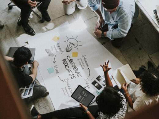 Business people brainstorming ideas using a chart